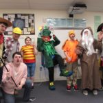 Group of students and staff in halloween costumes