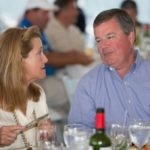 Woman and Man in conversation at a table during the 2013 Howard F. Treiber Memorial Golf Outing