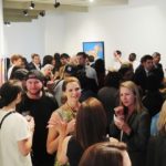 crowd mingling in an art gallery