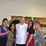 four women posed with man in chef coat