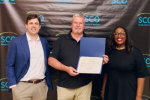 Caption: Left to right: Madonna Heights Golf Classic Co-Chair Paul Tyree, Madonna Heights Golf Classic Honoree Ed Pedchenko, and SCO Family of Services President & CEO Suzette Gordon.